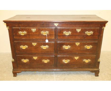 A GEORGIAN LANCASHIRE OAK DRESSER, c.1800, the moulded edged hinged top opening to interior with till box, the fascia with fo