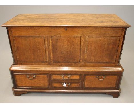AN OAK AND MAHOGANY BANDED CHEST ON STAND, 18th century and later, with moulded edge and hinged plank lid, the fascia with th