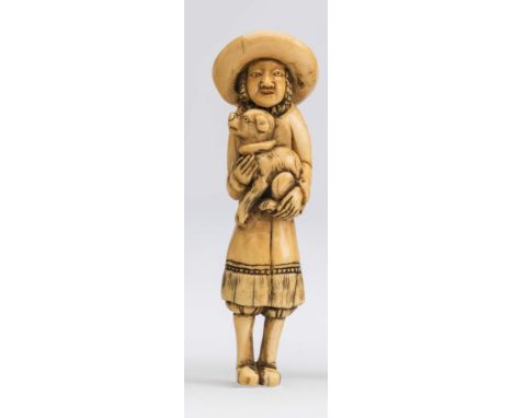 A JAPANESE IVORY NETSUKE, 18th century, carved as a Dutchman, standing holding a puppy in his arms, unsigned, 3 1/2" high (Es