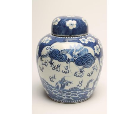 A CHINESE PORCELAIN JAR AND COVER of ovoid form, painted in underglaze blue with two panels, one of a pair of tigers on a riv