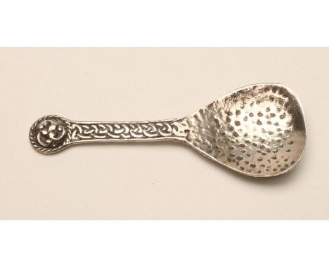 A SILVER CADDY SPOON, maker Ward Bros., Edinburgh 1957, the fig shaped bowl crudely spot hammered with Iona type knot cast ha