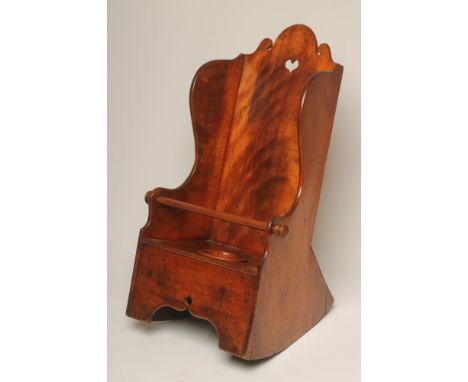 A CHILD'S CHERRY WOOD WING ROCKING CHAIR, 19th century, the arched scrolled back with pierced heart handle, commode seat, sta