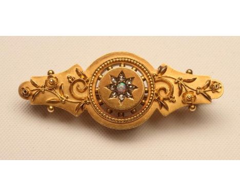 A LATE VICTORIAN 15CT GOLD BROOCH, the open roundel centred by a small opal within a border of eight rose cut diamonds to fil