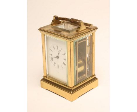 A BRASS CASED CARRIAGE CLOCK, the twin barrel movement with platform escapement striking on a gong, white enamel dial with Ro