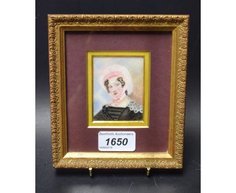 A 19th century portrait miniature, lady wearing a pink and white bonnet, black dress, lace trim, oil on ivory panel, unsigned