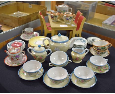 A child`s part ceramic tea service for six; other part services; a scratch built dolls house dining suite
