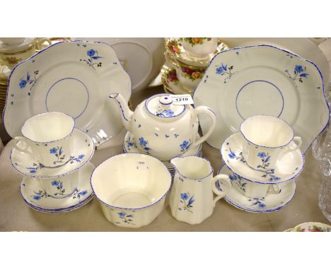 An early 20th century blue floral hand painted tea service for six comprising teapot, side plates, bread and butter plates, c