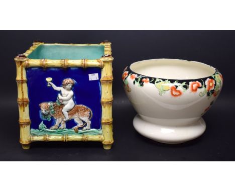 A Victorian majolica square planter, applied with Bacchic infants astride beasts, bamboo frame, c.1870; another planter (2)
