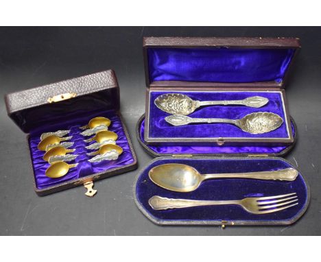 A set of silver silver and gold gilt egg spoons; a pair of silver fruit spoons, embossed with  ripe fruit and flowers; anothe