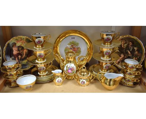 A Continental Lamoges style gilt coffee service for six; another tea service similar; a pair of collectors plates with cherub