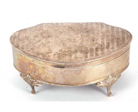 A George V silver ring box of cartouch form, the hinged lid with engine turned bands, having plain sides and supported on fou