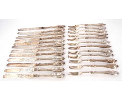 A Victorian silver dessert service for twelve, the blades chased and engraved with scrolls etc, hallmarked for Sheffield 1856