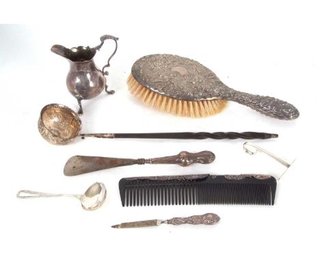 A Georgian silver cream jug, marks rubbed (a/f), a hallmarked silver baby's food pusher, Birmingham 1951, makers mark for Rob