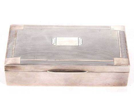 An Art Deco silver table cigarette box of rectangular form having engine turned geometric design hinge lid, the bottom sectio