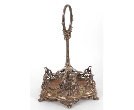 A large Victorian silver framed cruet stand of six divisions with ornate oval loop carrying handle, the scroll framed pierced