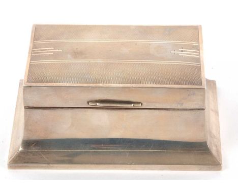 A hallmarked silver table cigarette box, the hinged lid with engine turned decoration with plain silver sides, wood interior 