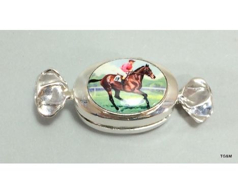 An unusual silver ring box in the form of a sweet with enamel set to the lid