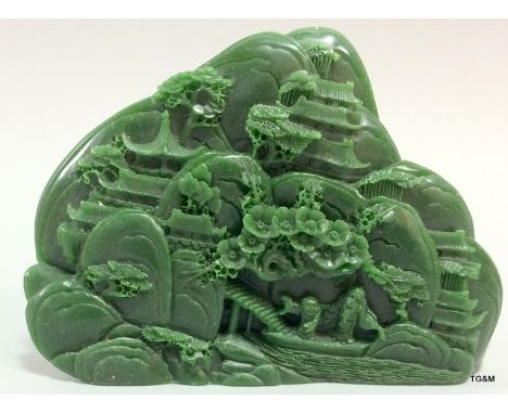 A chinese carved jade tablet depicting figures in a village