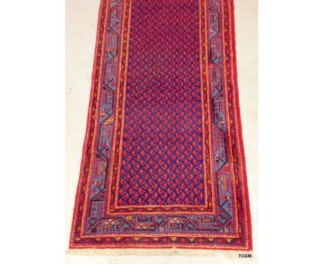 A Tabriz quality carpet repeated design in blue and red 420 x 107