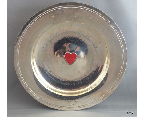 Silver Armada dish with enamel heart to the centre with inscription for the Variety Club Convention 1966. 525gm 22.5cm diamet