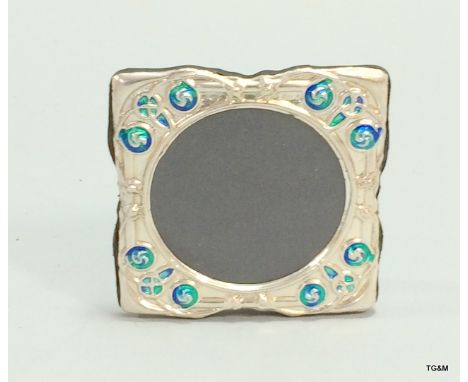 A silver and enamel set easel back picture frame