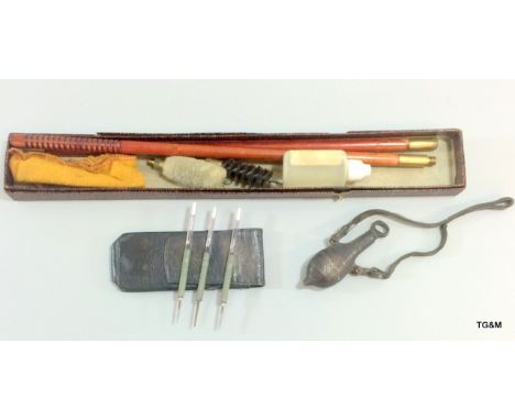 A gun cleaning kit, old powder flask and set of old darts