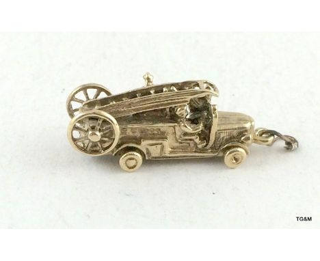 9ct gold charm in the shape of an old style fire engine 