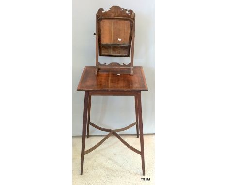 A mahogany inlaid lamp table with cross stretcher together with a carved frame dressing table mirror