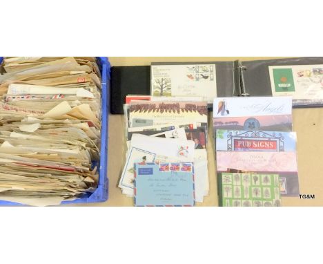 A collection of first day covers and envelopes with stamps still attached from all parts of the world including military
