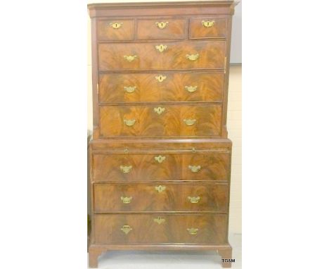 A Victorian flame mahogany chest on chest of 3 over 6 drawers, brass handle and brush slide on bracket feet