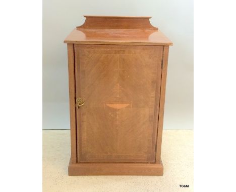 A mahogany inlaid multi shelf music cabinet