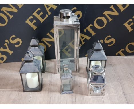 A LARGE CHROME CANDLE LANTERN TOGETHER WITH 3 BATTERY POWERED CANDLE LANTERNS AND 2 OTHERS