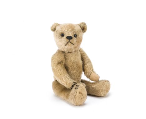 An American teddy bear 1910-20s,  with dark golden mohair, black boot button eyes, black stitched nose, mouth and claws, swiv