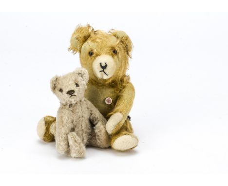 A small post-war Steiff teddy bear, With beige mohair, brown and black glass eyes, black stitched nose and mouth, swivel head