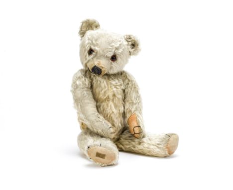 A 1930s Merrythought teddy bear,  With golden mohair, large orange and black glass eyes, pronounced clipped muzzle, black sti