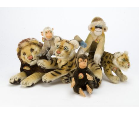 Six post-war Steiff wild animals, a running leopard —9in. (23cm.) long, a reclining tiger and lion, Jocko, Mungo and Coco mon