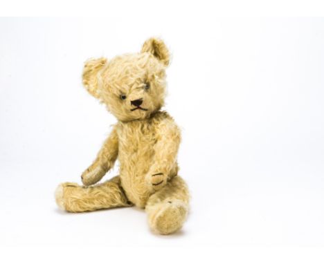 A post-war teddy bear,  Possibly French, light golden mohair, clear and black glass eyes, black stitched nose, mouth and claw