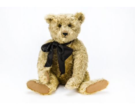 A 1920s Steiff teddy bear,  with golden mohair, brown and black glass eyes, pronounced part clipped muzzle, black stitched no