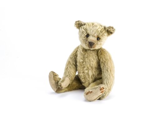 An early Steiff teddy bear circa 1908, With dark blonde mohair, black boot button eyes, pronounced clipped muzzle, black stit