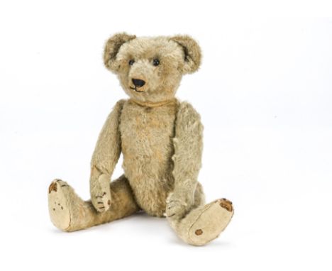 A Strunz teddy bear circa 1907, With blonde mohair, black boot button eyes, pronounced muzzle, black stitched nose, mouth and