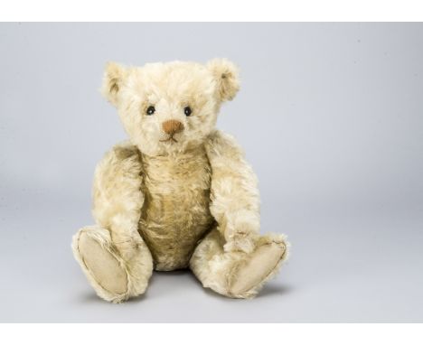 A fine and early Steiff white centre-seam teddy bear 1908,  with black boot button eyes, pronounced clipped muzzle, black sti