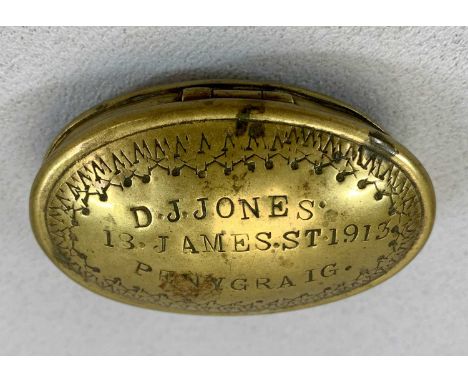 WELSH OVAL BRASS SNUFF BOX, the hinged cover with decoration to the border, inscribed 'D J Jones, 13 James Street, Penygraig 