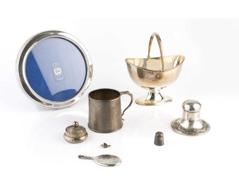 A silver swing handled sugar basket, with reeded borders, on oval pedestal foot, Birmingham 1962, 13.5cm wide, and a silver c