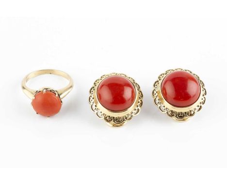 A pair of coral ear clips, each coral corallium rubrum cabochon collet set within a pierced scalloped border, on hinged clip 