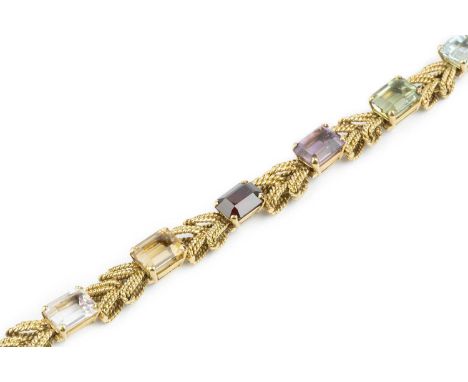 A vari gem-set bracelet, of herringbone-link design, spaced by vari-coloured rectangular step-cut gemstones to include amethy