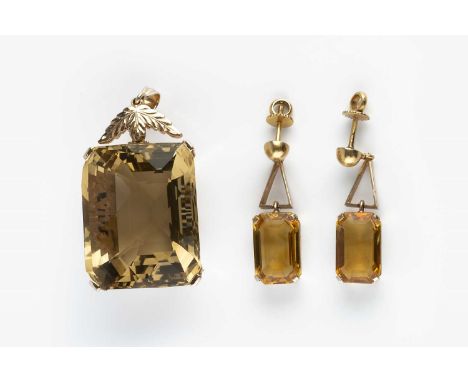 A smoky quartz single stone pendant, the rectangular fancy-cut smoky quartz in four claw setting, with foliate decorated gall