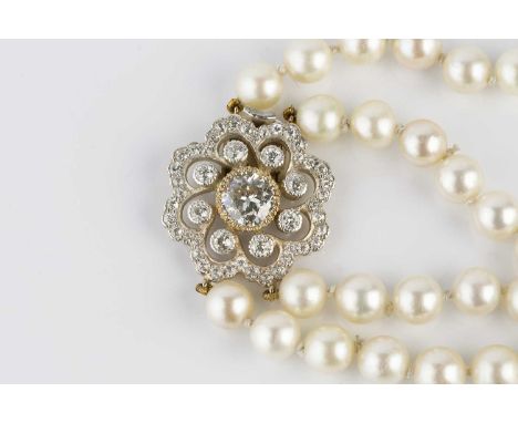 A double strand cultured pearl necklace with diamond clasp, comprising two strands of uniform cultured pearls, each measuring