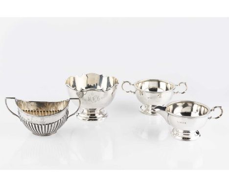 An Edwardian silver sugar bowl, with shaped border, on pedestal foot, by Barker Bros., Birmingham 1904, 11.5cm wide, a silver