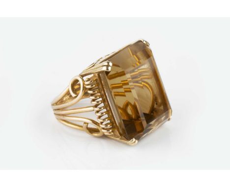 A French citrine single stone cocktail ring, the rectangular step-cut citrine in four claw setting, to a tapered scrolled wir