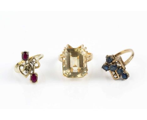 Three gem set dress rings, comprising a sapphire and diamond dress ring, of abstract geometric design, with a tiered spray of